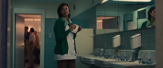 Wide shot frame from Battle of the Sexes — book, standing, door