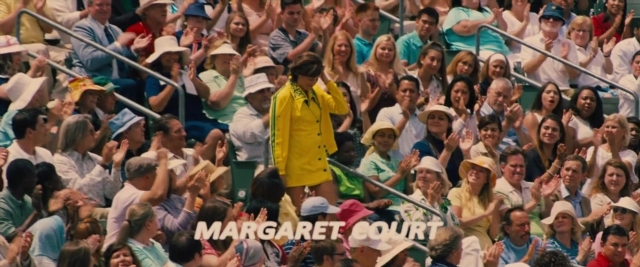 Wide shot frame from Battle of the Sexes — standing, hat, person
