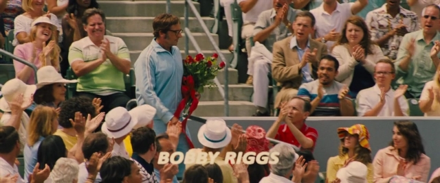 Wide shot frame from Battle of the Sexes — standing, shirt, person