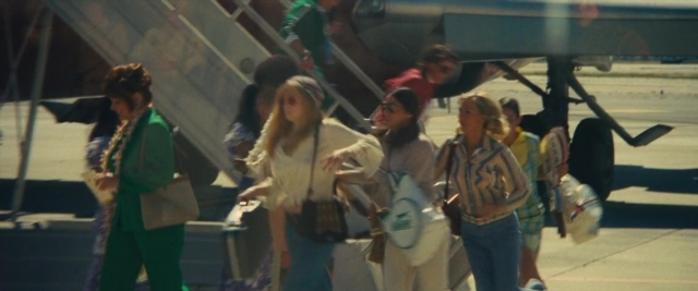 Frame from Battle of the Sexes — walking, face, hair