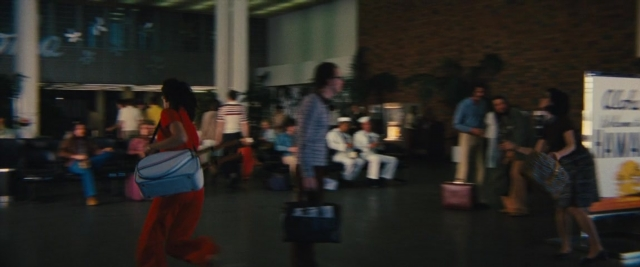 Wide shot frame from Battle of the Sexes — sitting, standing, walking
