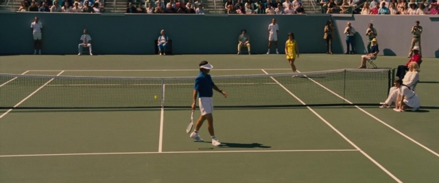 Wide shot frame from Battle of the Sexes — sitting, standing, shirt