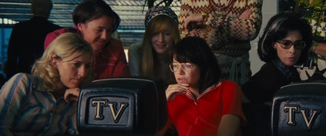 Wide shot frame from Battle of the Sexes — sitting, room, table