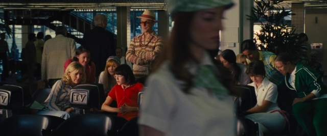 Medium shot frame from Battle of the Sexes — sitting, standing, hat