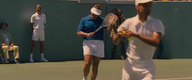 Medium shot frame from Battle of the Sexes — sitting, standing, hat