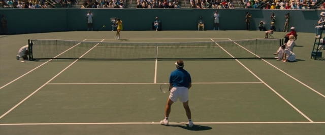 Wide shot frame from Battle of the Sexes — standing, shirt, ball