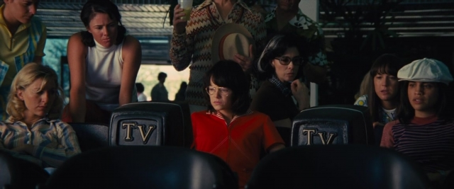Wide shot frame from Battle of the Sexes — sitting, face, person