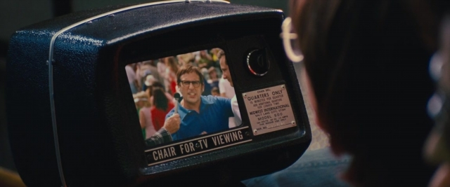 Wide shot frame from Battle of the Sexes — shirt, television, chair