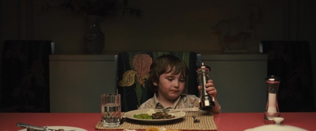 Wide shot frame from Battle of the Sexes — sitting, plate, table