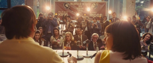 Wide shot frame from Battle of the Sexes — table, person, human face