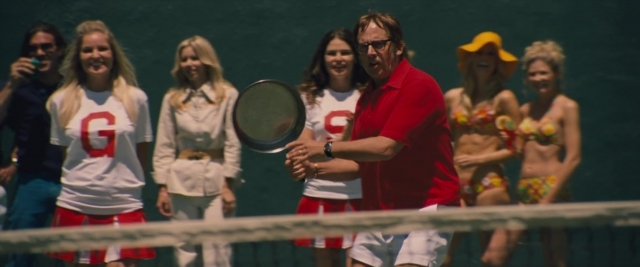 Wide shot frame from Battle of the Sexes — standing, hand, shirt