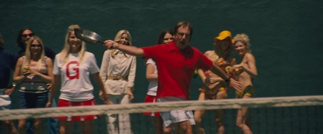 Wide shot frame from Battle of the Sexes — standing, hat, shirt