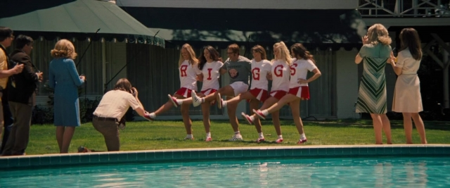 Wide shot frame from Battle of the Sexes — standing, person, human face