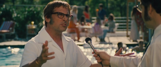 Wide shot frame from Battle of the Sexes — sitting, standing, dialogue