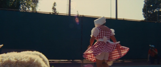Wide shot frame from Battle of the Sexes — hat, dress, person