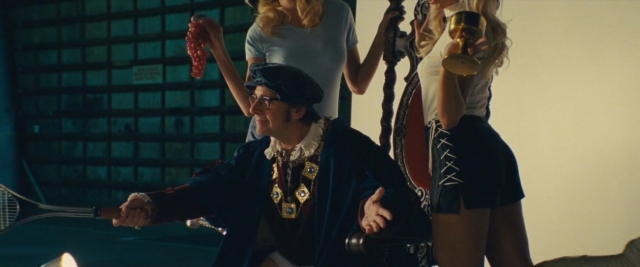 Frame from Battle of the Sexes — standing, hat, hand