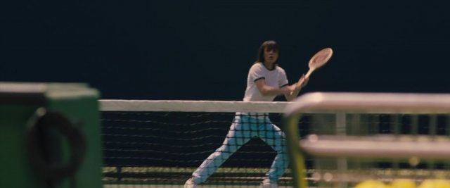 Wide shot frame from Battle of the Sexes — hand, night, shirt