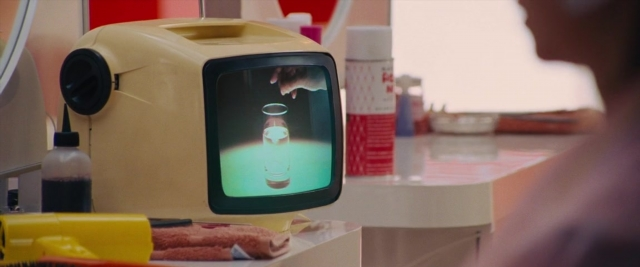 Wide shot frame from Battle of the Sexes — mirror, hand, water