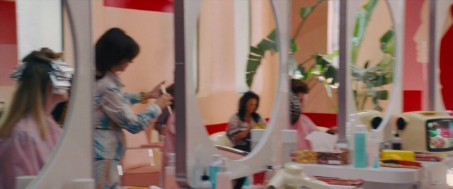Wide shot frame from Battle of the Sexes — sitting, table, mirror