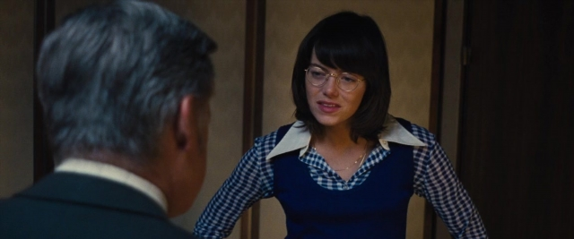 Wide shot frame from Battle of the Sexes — standing, dialogue, door