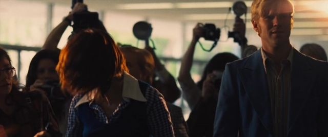 Wide shot frame from Battle of the Sexes — walking, suit, tie