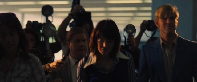 Wide shot frame from Battle of the Sexes — walking, room, dialogue