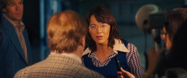 Wide shot frame from Battle of the Sexes — standing, room, dialogue