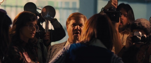 Wide shot frame from Battle of the Sexes — dialogue, suit, tie