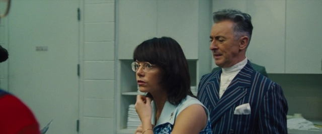 Wide shot frame from Battle of the Sexes — standing, room, dialogue