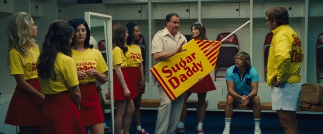 Wide shot frame from Battle of the Sexes — sitting, room, shirt