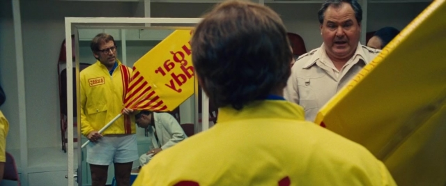 Wide shot frame from Battle of the Sexes — standing, room, door