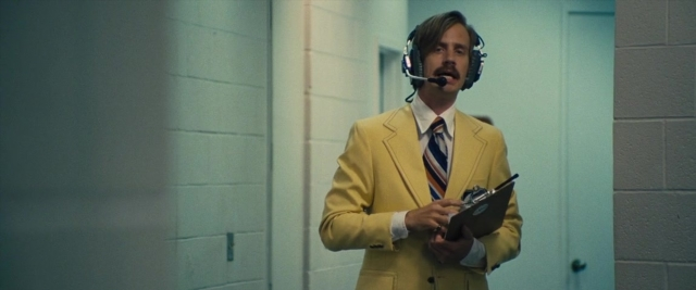 Wide shot frame from Battle of the Sexes — standing, door, hand