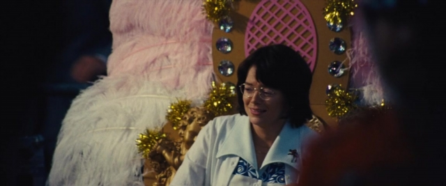 Wide shot frame from Battle of the Sexes — sitting, dialogue, shirt