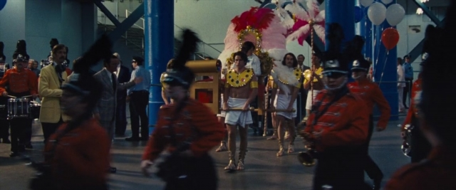 Medium shot frame from Battle of the Sexes — walking, room, street