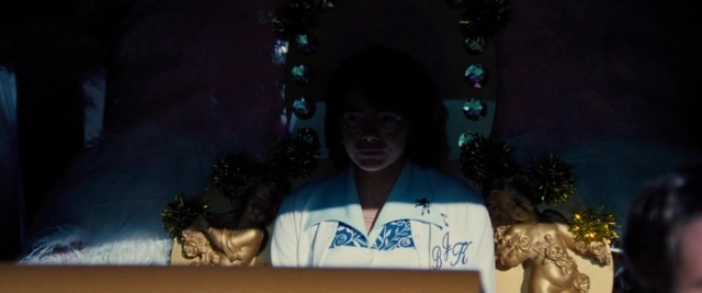 Wide shot frame from Battle of the Sexes — sitting, room, table