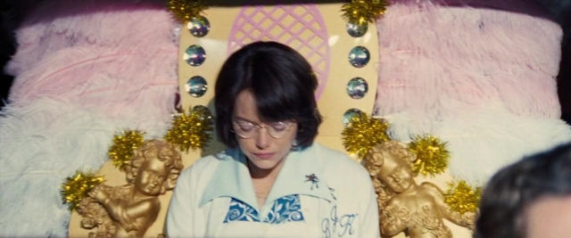 Wide shot frame from Battle of the Sexes — sitting, chair, face