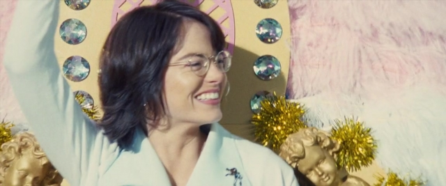Frame from Battle of the Sexes — hand, hair, bird