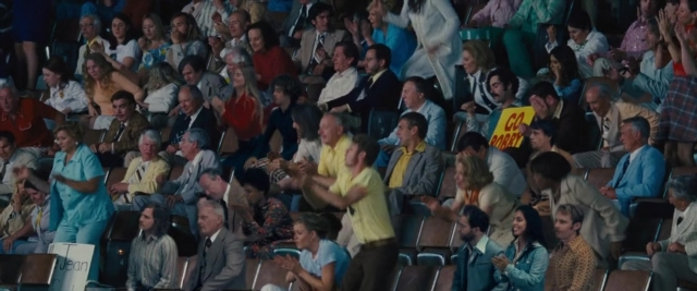 Wide shot frame from Battle of the Sexes — sitting, person, human face