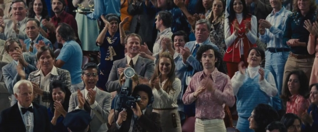 Wide shot frame from Battle of the Sexes — standing, suit, tie