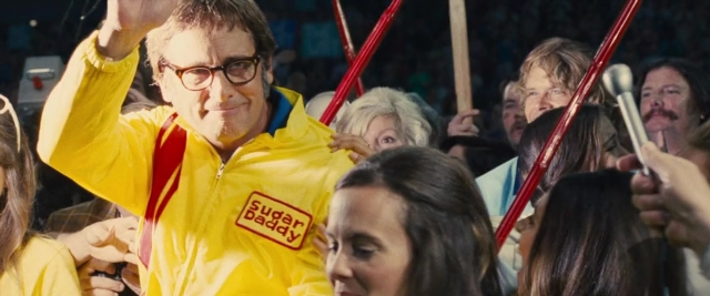 Wide shot frame from Battle of the Sexes — standing, night, hair