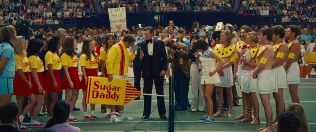 Wide shot frame from Battle of the Sexes — standing, suit, tie