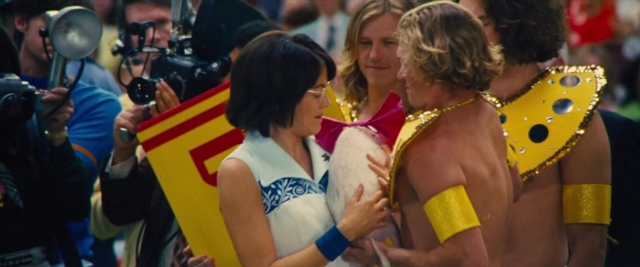 Wide shot frame from Battle of the Sexes — dress, hair, person