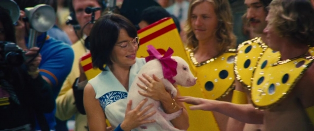 Wide shot frame from Battle of the Sexes — dog, dress, person