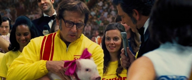 Wide shot frame from Battle of the Sexes — standing, suit, tie
