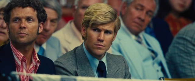 Medium shot frame from Battle of the Sexes — sitting, suit, tie