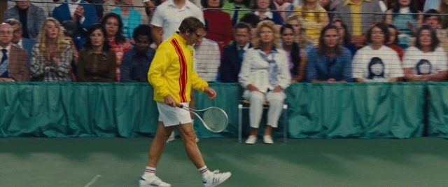 Wide shot frame from Battle of the Sexes — sitting, standing, walking