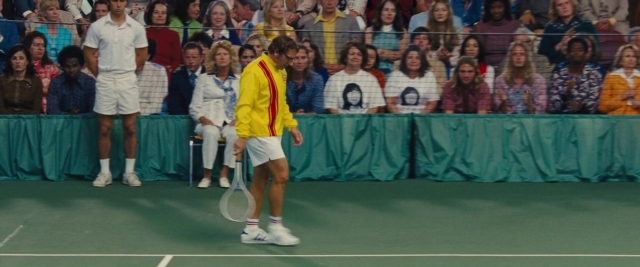 Wide shot frame from Battle of the Sexes — sitting, standing, walking