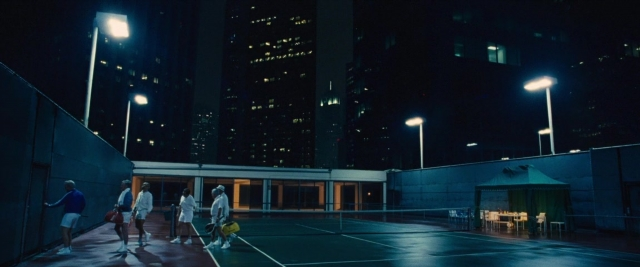 Wide shot frame from Battle of the Sexes — walking, street, night