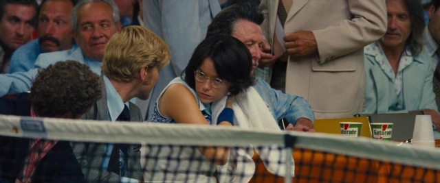 Wide shot frame from Battle of the Sexes — sitting, table, dialogue