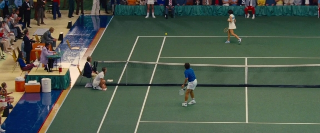 Wide shot frame from Battle of the Sexes — sitting, standing, shirt